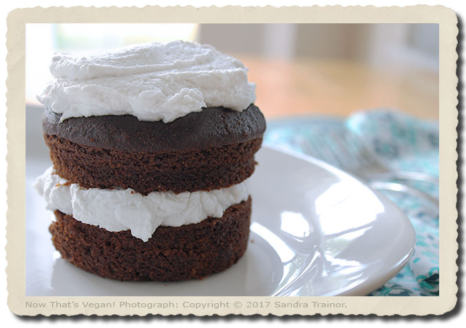 a small chocolate cake with coconut whipped cream.